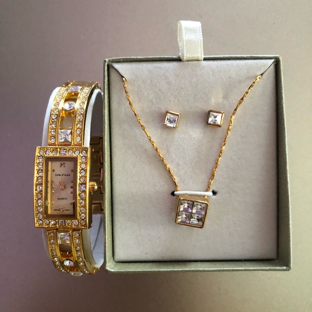 A watch with stud earrings and matching necklace